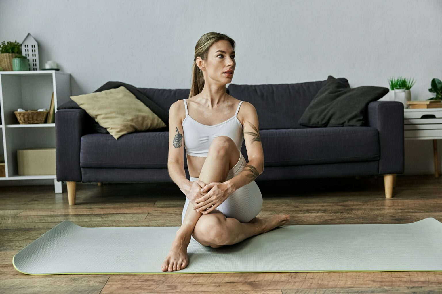 Woman practicing yoga in modern apartment