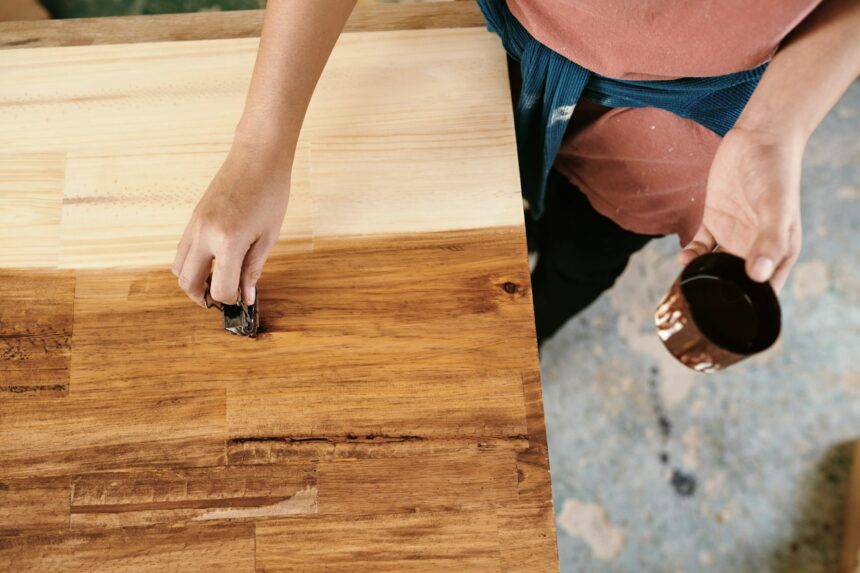 Carpenter applying wood lacquer