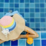 Woman relaxing at swimming pool, Summer vacation