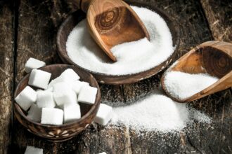 Sugar with a scoop in a bowl.